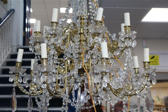 An 18th century style gilt brass and glass sixteen light chandelier, drop 3ft 6in. diam.2ft 8in.
